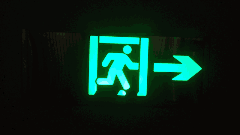 an animated gif, an exit sign that degrades into pure noise